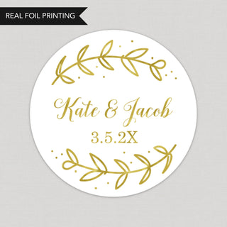 a round wedding sticker with gold leaves on it