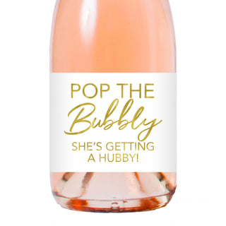 a bottle of wine with the words pop the bubbly she's getting a