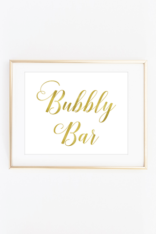 a framed print with the words bubbly bar in gold foil