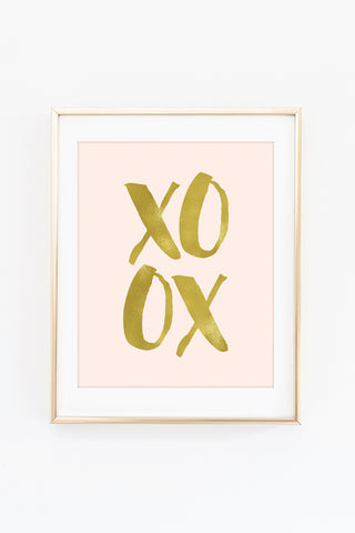 a picture of the word xo in gold foil on a pink background