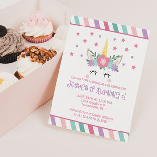 a box of cupcakes with a unicorn on top