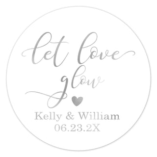 a round sticker with the words let love glow on it