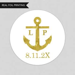 a round sticker with a gold anchor on it