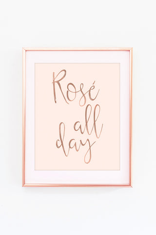 a rose all day print hanging on a wall
