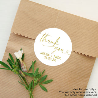 a thank you sticker on top of a brown paper bag