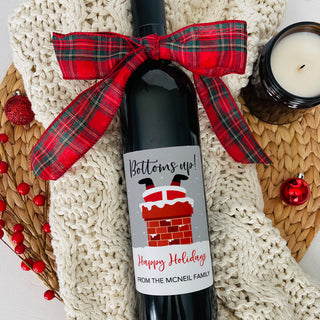 a bottle of wine with a red bow on it